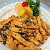 Golden Calamari · (Medium spicy). Calamari strips tossed in flour, fried till golden brown and crispy, seasone...