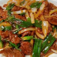 Mongolian Beef · Sliced tender beef stir-fried with scallions and white onions in a brown sauce.