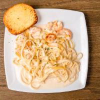 Shrimp Fettuccine Alfredo · Homemade pasta and served with garlic bread.