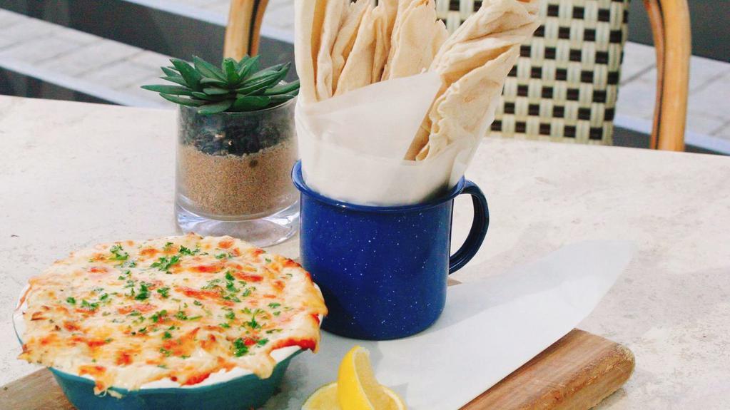 Spinach & Crab Dip · Baked spinach, crab, artichokes and cheese blend and pita bread.