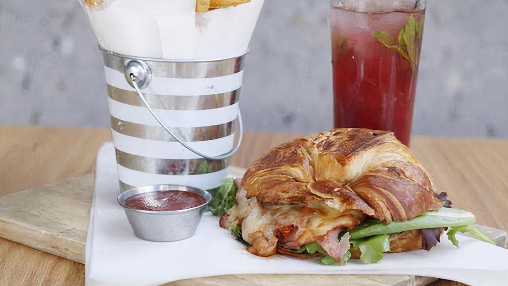 Classic French Croissant · Ham slices, munster-swiss mix, sundried tomato pesto, spring mix and dijon spread.