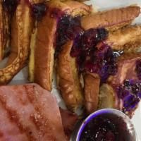 French Toast · Texas toast, maple syrup, and powdered sugar with a berry compote, and choice of bacon, Blu ...