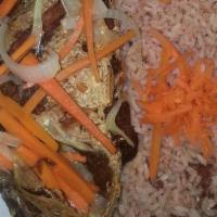 Escoveitch Fish · Bone-in fish seasoned with Jamaican spices, pan-tried then marinated in onions, peppers, and...