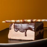Triple Chocolate Cake · Two layers of chocolate cake covered in chocolate mousse frosting topped with chocolate gana...