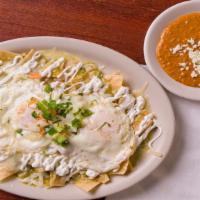 Chilaquiles Especiales Plate · Corn chips with 2 eggs, Salsa roja, sour cream, white cheese and pico de gallo served with b...