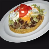 Sope · A thick tortilla deep fried topped with beans, choice of meat, lettuce, sour cream, salsa, a...