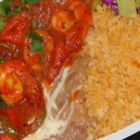 Camarones A La Diabla · Fried shrimp bathed in red spicy sauce with onions, served with rice and beans and tortillas...