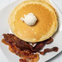 Buttermilk Pancakes · Three large buttermilk pancakes served with ham, bacon or sausage.