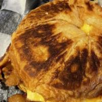Croissant · Flaky croissant, fried or scrambled egg, mayo, cheese with your choice of ham, bacon or saus...