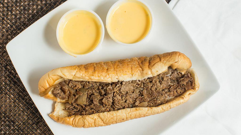 Cheezy Cheesesteak · Our authentic philly cheesesteak sandwich, topped with American swiss cheese and our homemade queso sauce.