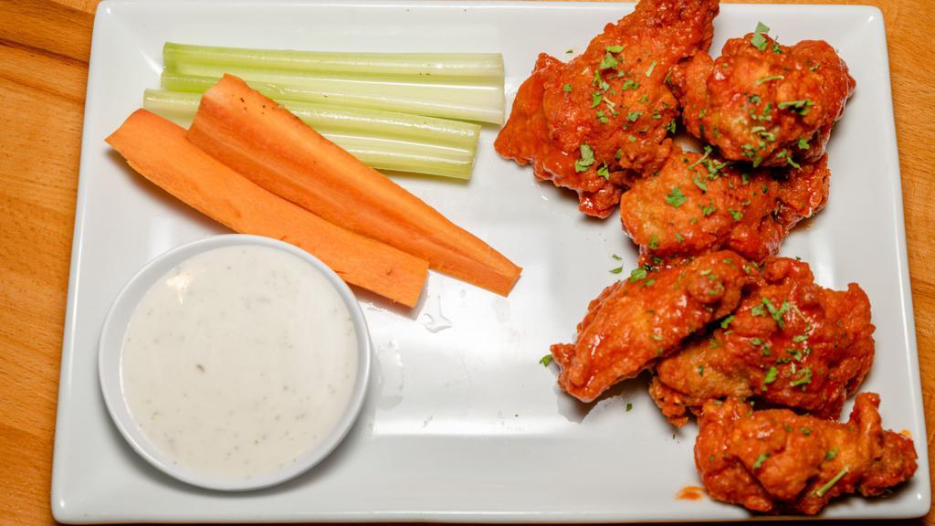 Buffalo Wings · Six wings tossed in buffalo sauce and served with a side of ranch and crunchy celery sticks.