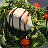 Burrata Apulia · Peppery arugula and grape tomatoes lightly coated in olive oil and pesto topped with fresh b...