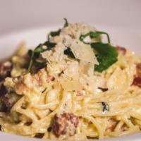 Carbonara Di Roma · Old fashioned spaghetti with salt-cured pancetta in a hardy basil cream sauce topped with fr...