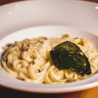 Fettuccine Alfredo · Satisfying classic tossed in a creamy alfredo sauce and topped with shaved Parmesan cheese.