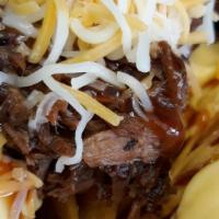Carlton'S Nachos · A pile of corn tortilla chips topped with chopped brisket, sauce and queso. Jalapenos on the...