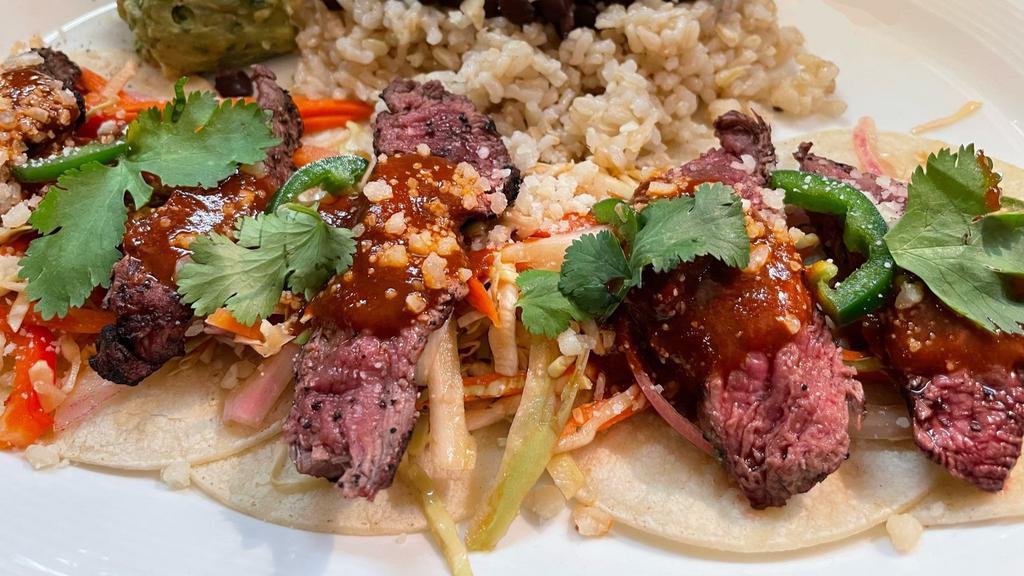 Steak Tacos · blackened and seared, red chile sauce, cilantro, parmesan, beans, rice