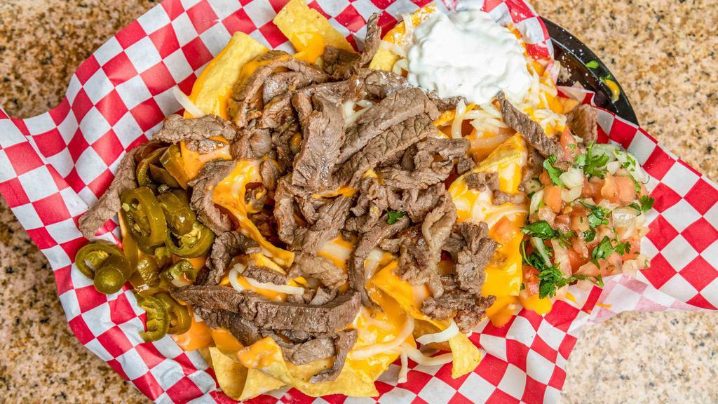 Nachos · Freshly fried tortilla chips, melted nacho cheese with 1 meat, shredded cheese, jalapeños, pico de gallo, sour cream, and red or green salsa. Add extra shredded cheese, extra melted nacho cheese, and add extra jalapeño for an additional charge.
