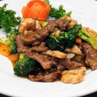 Triple Delight · Marinated beef, shrimp, chicken, sauteed with fresh mushrooms and vegetables in a special ho...