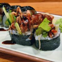Spider Roll · Soft shell crab, masago, crab cucumber, avocado, gobo and radish sprouts rolled with rice ou...