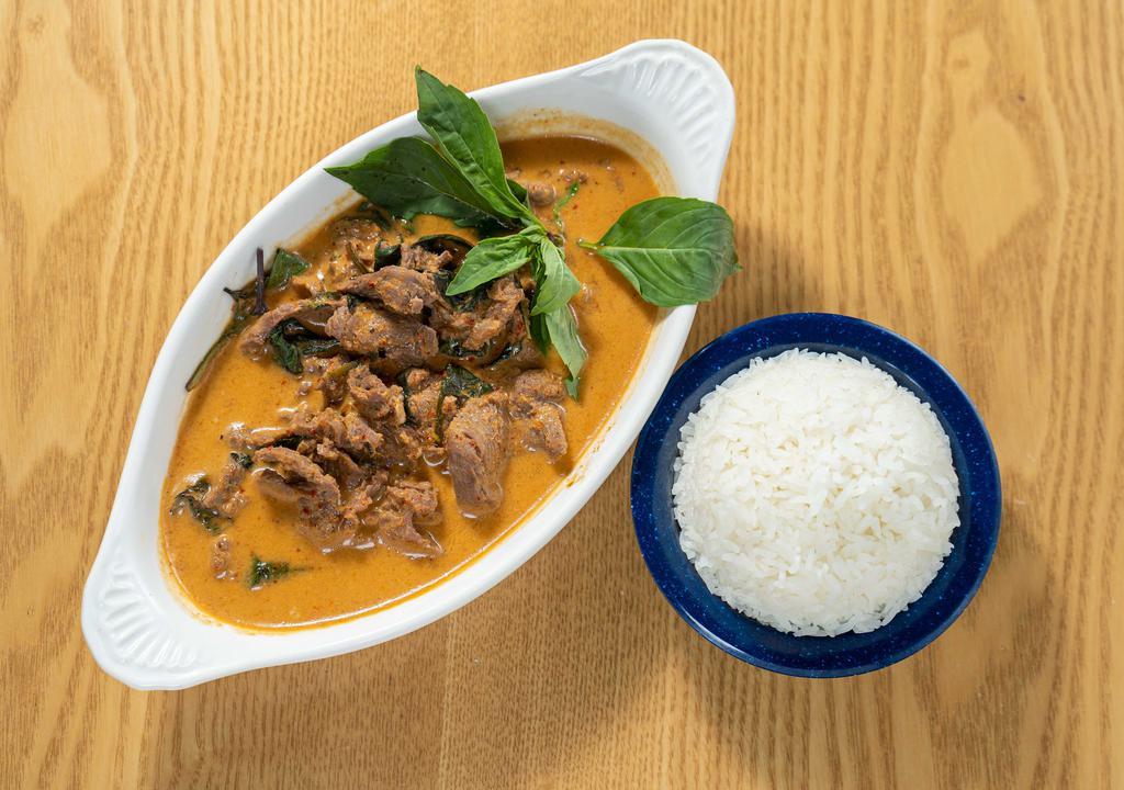 Panang Curry · Spicy. Thai red curry w/ shredded kaffir lime leaves & Thai basil.