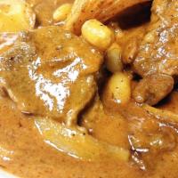 Mam’S Special Masman Beef Curry · Spicy. Slowly cooked beef chunks in Thai red curry w/ whole golden potatoes, onions, peanuts...