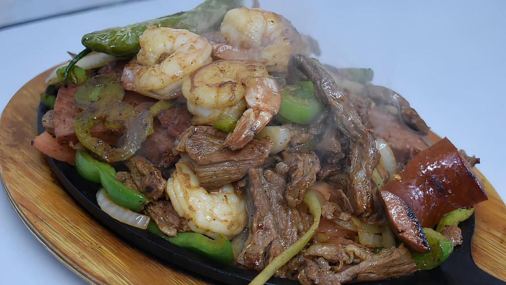 Parrillada De Fajita Mixta · Beef, shrimp, sausage, rice, beans, nopales, and pico de Gallo.