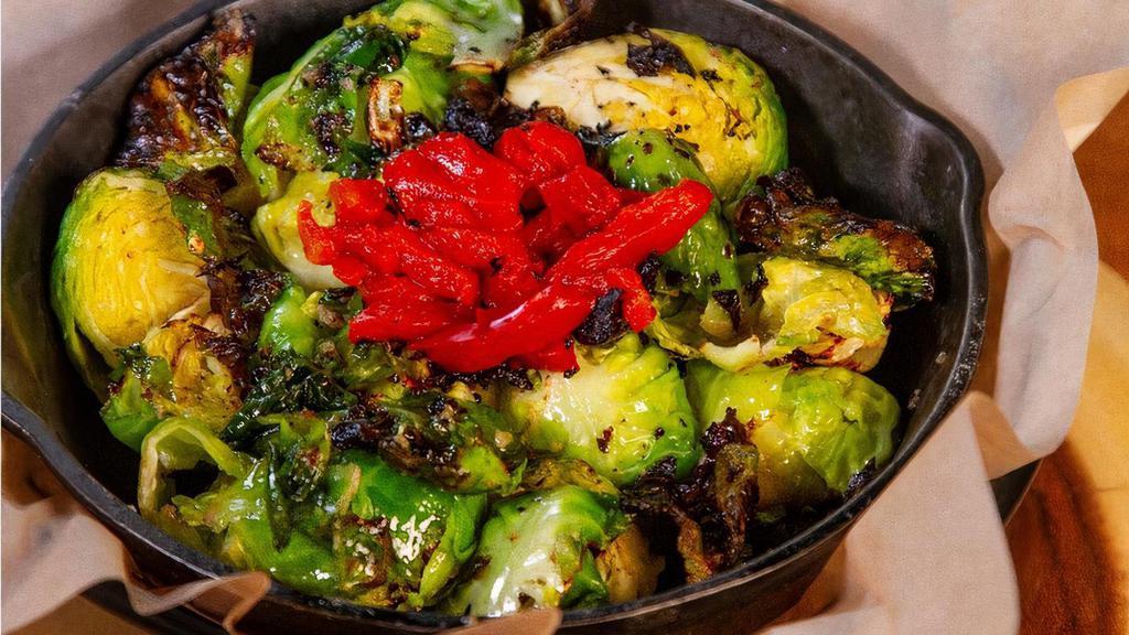 Brussels Sprouts · Baked and tossed in garlic butter with fire-roasted red peppers.