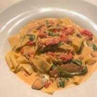 Mario'S · Pappardelle pasta, spicy Italian sausage, portabello mushrooms, sundried tomatoes, spinach, ...