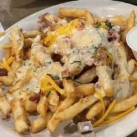 Loaded Cheese Fries · French fries topped with cheese, bacon, chives, and a dab of sour cream.