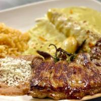 Carne Asada · Butterfly flat iron steak served with grilled onions, chile toreado, one enchilada suiza, ri...