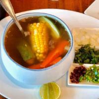 Caldo De Res · Beef and vegetable soup, served with a side of rice and flour or homemade corn Tortillas.
