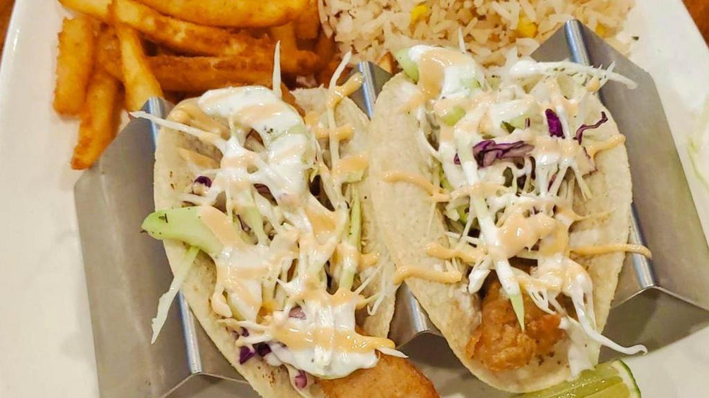 Tacos Ensenada (Pescado) · Three house made corn Tortillas, tempura battered tilapia fish with chipotle cream sauce and coleslaw served with fries and white rice.