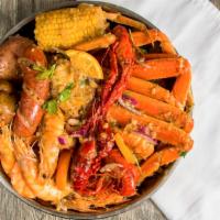 Seafood Combo Package 4 · One lb crawfish, one corn, one potato, one sausage, 1/2 lb shrimp, one cluster snow crab.