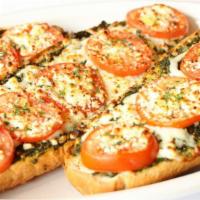 Greek Bread · Palio's pesto, tomatoes, olive oil, feta and mozzarella.