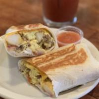 Breakfast Burrito · Flour tortilla, eggs, potatoes, cheddar and your choice of bacon, breakfast sausage or chori...