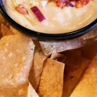 Chips And Queso. · Chips and White Queso served with Pico de Gallo