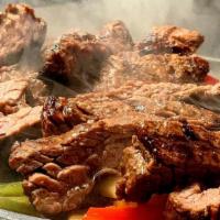 Fajitas · Chicken, Beef, or Combo. Served with hand cut onions, peppers, choice of rice, beans, and to...
