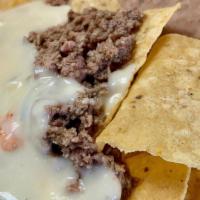 Ninos Nachos · Chips, ground beef, queso Served with Rice and Beans