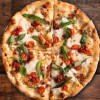 Ma Lady Pizza · White sauce, fresh Mozzarella, roasted tomatoes, bacon, basil, Ricotta, Parmesan.