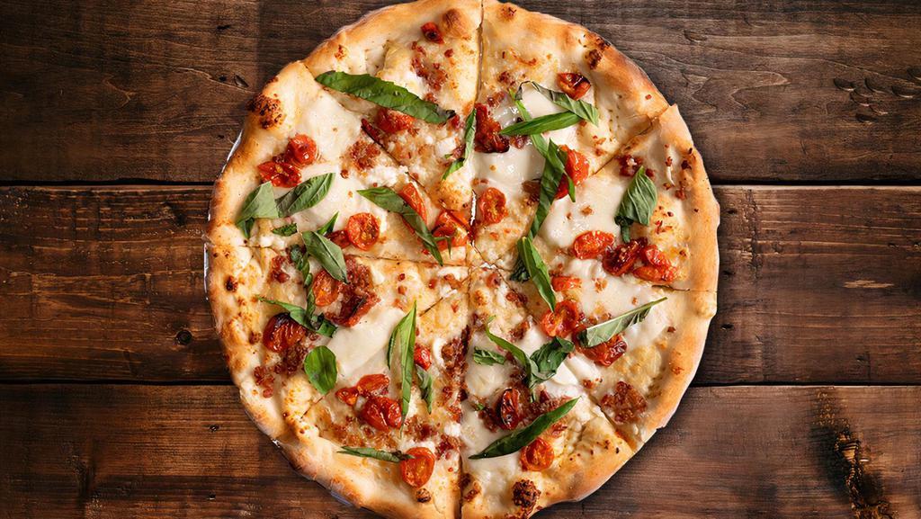 Ma Lady Pizza · White sauce, fresh Mozzarella, roasted tomatoes, bacon, basil, Ricotta, Parmesan.