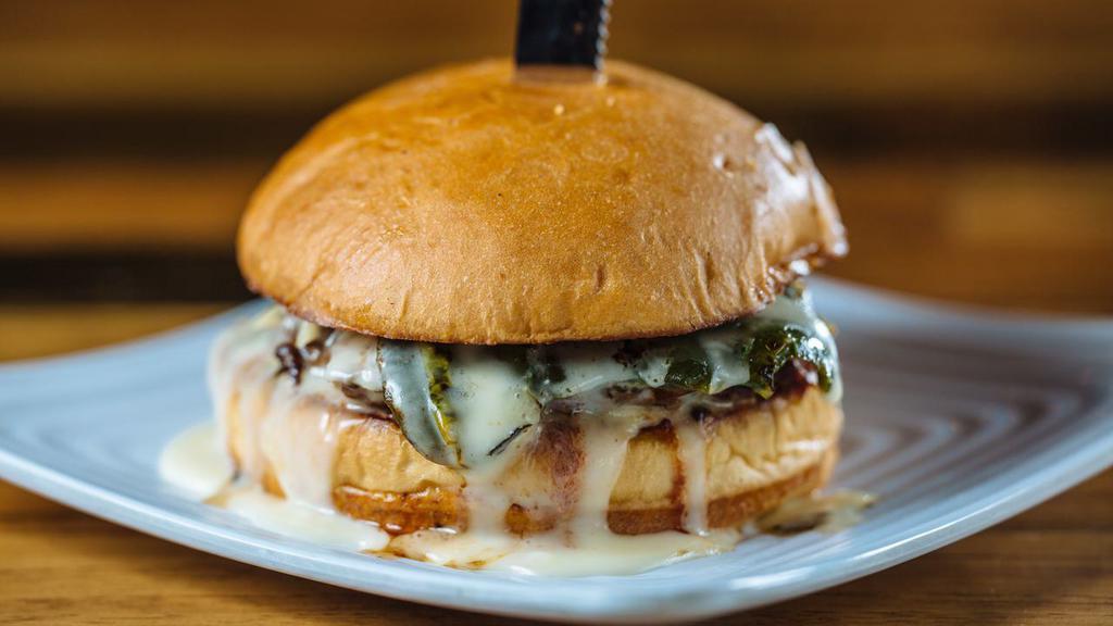Chillerno · Our custom Beef Blend Patty topped with Queso Blanco, a Fire-Roasted Poblano Pepper, and Chipotle BBQ sauce on a toasted Brioche Bun.