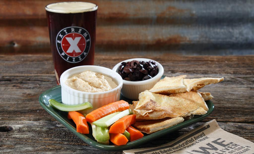Pizza Chips With Hummus · The perfect appetizer pizza dough baked and presented with our homemade hummus for dipping.