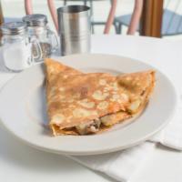 Breakfast Taco Crepe · Mixed cheese, egg, fried potatoes, onions, and garlic with salsa.