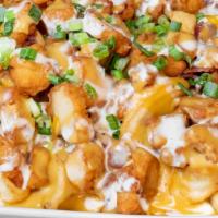 Loaded Bayou Fries · Fries topped with fried gator bites, shredded cheddar cheese, bacon, spicy andouille cream s...
