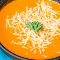 Tomato Bisque · A blend of tomato and basil with a touch of cream and parmesan cheese.