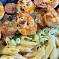 Bayou Pasta  · Grilled shrimp and andouille sausage atop an of cheesy, spicy pasta.