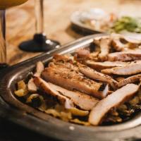 Fajitas · Choice of fajita meats on a sizzling skillet with a bed of onions & poblano peppers. Pico de...