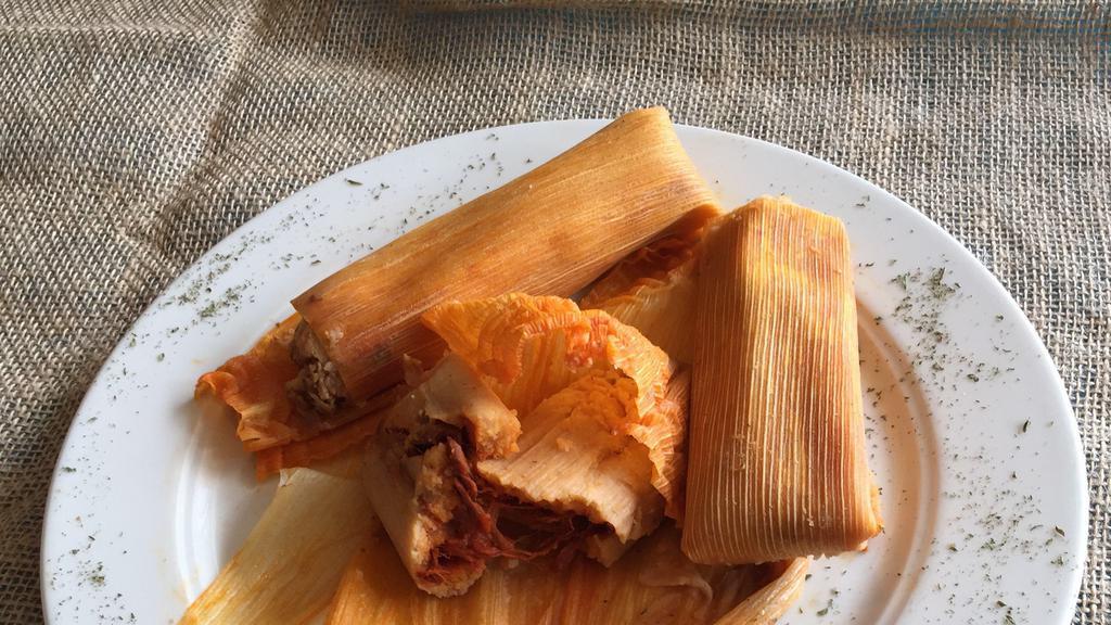 Tamales En Chilorio · Fresh homemade tamales, stuffed with seasoned pork, smothered with our chile con carne sauce & grated cheese. Served with mexican rice, refried beans, guacamole and sour cream.