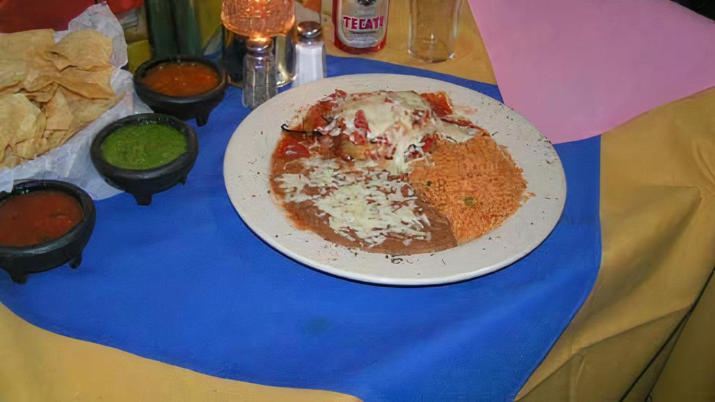 Chile Relleno · Poblano pepper encased in a meringue-like batter, stuffed w/your choice of shredded chicken breast, picadillo style ground beef or white cheese, topped w/choice of ranchero sauce or sour cream & shredded cheese. Mexican rice & refried beans.