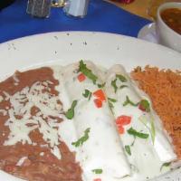 Enchiladas Vaqueras · 2 flour tortillas w/ beef or chicken fajita, topped w/ white queso sauce & pico. Mexican ric...
